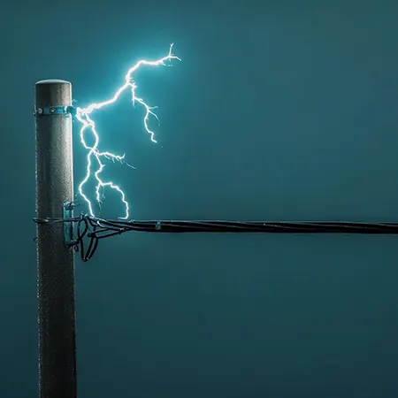 Lightning striking an overhead line, illustrating surge protection